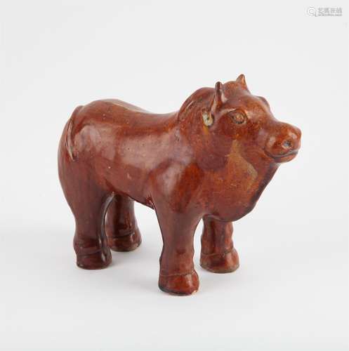 A large Chinese chestnut–glazed pottery figure of a bull, Ta...