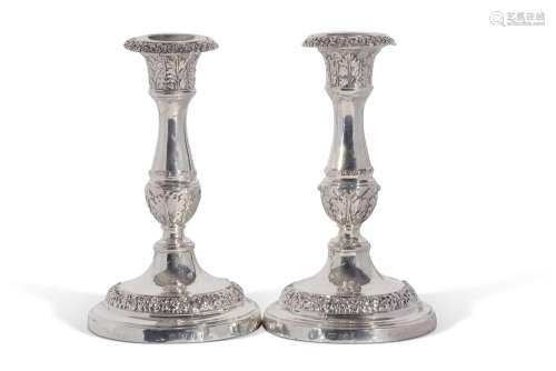 A pair of George IV candlesticks with baluster stem, and det...