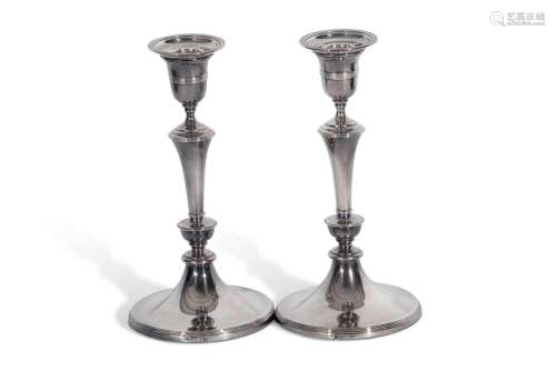 A pair of Edward Vll silver candle sticks, each with a ring ...