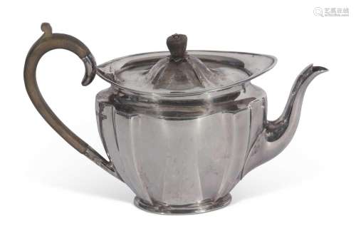 George V teapot of fluted oval tapering form with raised apr...