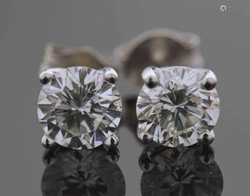 A pair of Diamond stud earrings each claw set with a round b...