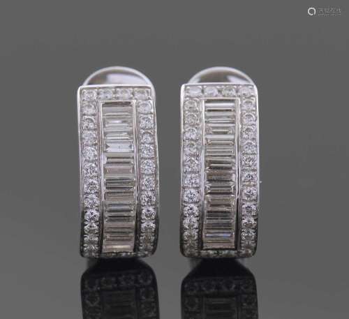 A pair of 18ct white gold and diamond curved earrings. A des...