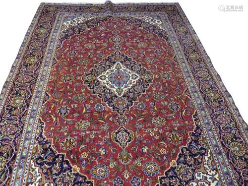 Iranian wool floor rug decorated with a large central red an...