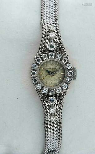 PERSEGAELE<br />
 Montre de dame en or gris sertie de diaman...