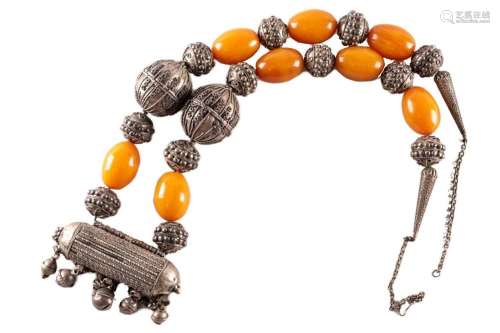 A large Yemeni silver metal and amber necklace, the metal wo...