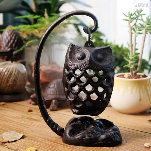 An owl iron candle holder