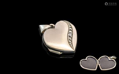 A 9ct White Gold Heart Shaped Locket, with single diamond. F...