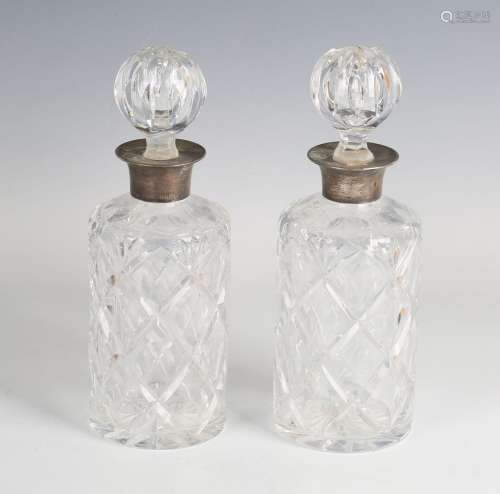 A pair of Elizabeth II silver mounted cut glass cylindrical ...
