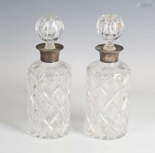 A pair of Elizabeth II silver mounted cut glass cylindrical ...