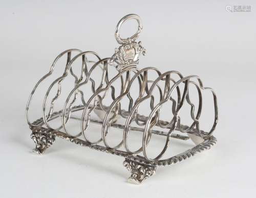 A George IV silver six-division toast rack, the foliate and ...