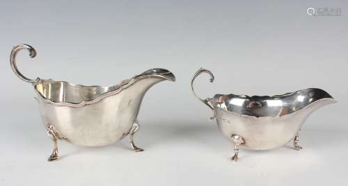 A George VI silver sauce boat with shaped rim and flying scr...