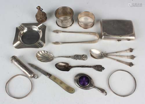 A group of silver items, including a curved rectangular ciga...
