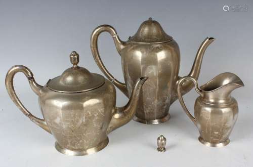 A German .800 silver three-piece tea set of ovoid faceted fo...