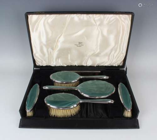 A George V silver mounted and teal green enamelled six-piece...