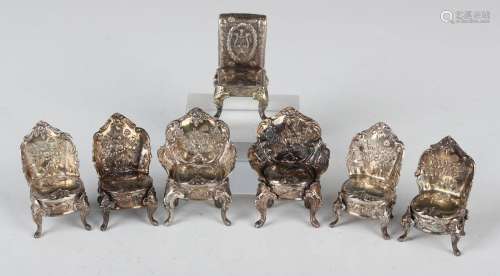 A set of six late Victorian silver toy chairs, each embossed...