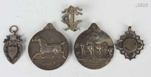 Two Edwardian silver medallions, one cast in relief with a g...
