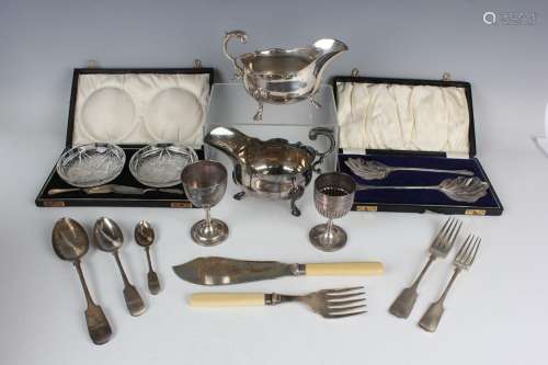 A group of plated items, including a pair of sauce boats and...