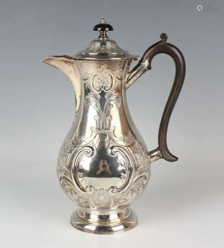 An Edwardian silver baluster hot water pot, embossed with op...