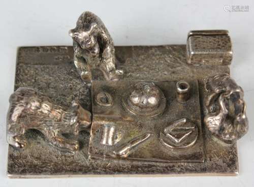 A Elizabeth II silver novelty menu holder, designed as three...