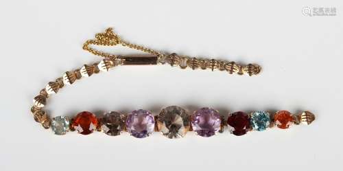 A gold and varicoloured gemstone bracelet, claw set with a r...