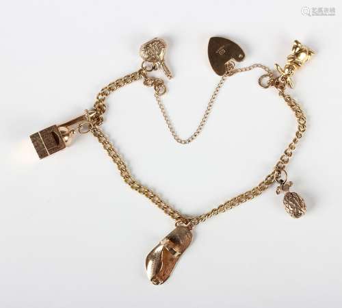 A 9ct gold curblink charm bracelet, fitted with five gold pe...