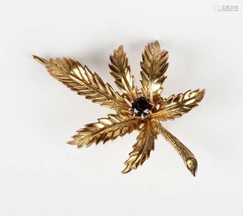 A 9ct gold and garnet single stone brooch, designed as a lea...