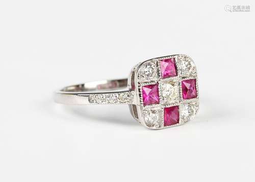 A platinum, ruby and diamond cluster ring in a shaped square...