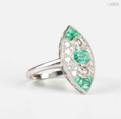 A platinum, emerald and diamond marquise shaped ring, the ce...