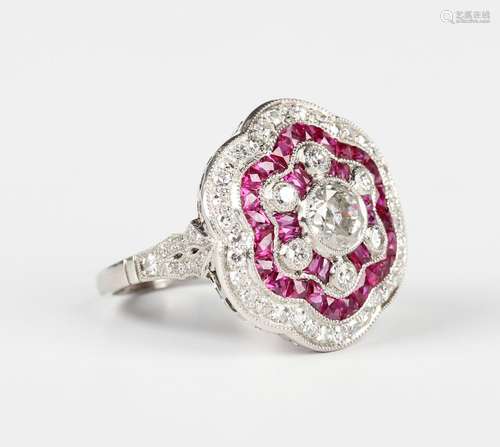 A ruby and diamond cluster ring in a flowerhead shaped desig...