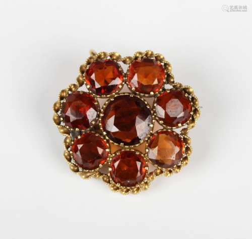 A Victorian gold and hessonite garnet cluster pendant brooch...