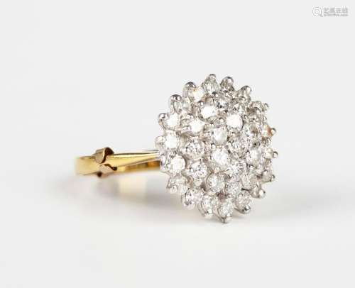 An 18ct gold and diamond cluster ring in a circular design, ...