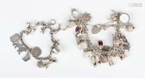 A silver curblink charm bracelet, fitted with a variety of m...