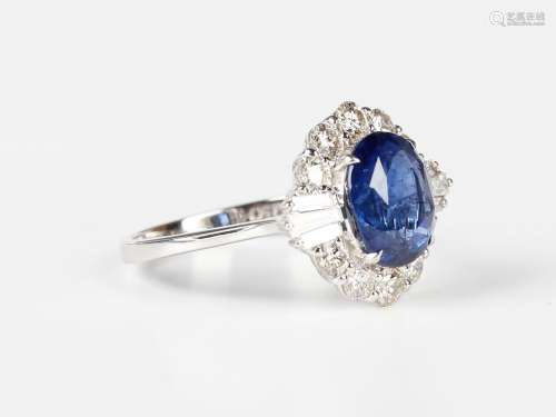 A white gold, treated sapphire and diamond cluster ring, cla...