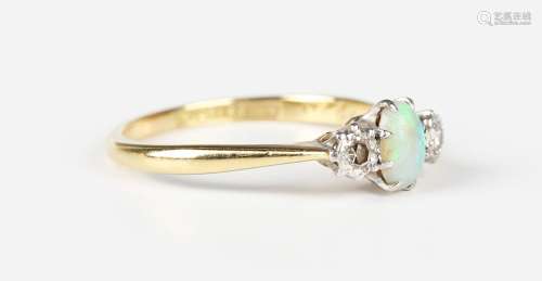 A gold and platinum ring, claw set with an oval opal between...