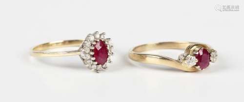 A 9ct gold ring, claw set with an oval cut ruby between two ...