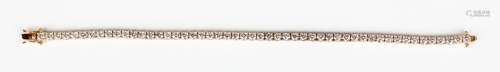 A rose gold and diamond bracelet, claw set with a row of cir...