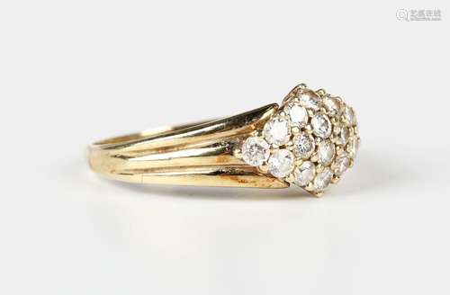 A gold and diamond marquise shaped cluster ring, claw set wi...