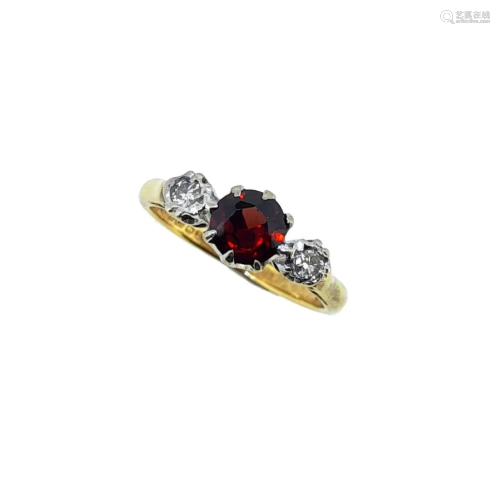 An 18ct gold garnet and diamond three stone ring,