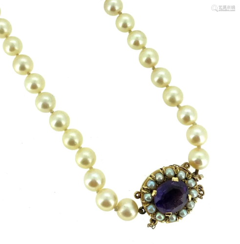 A single row of pearls with an amethyst clasp,