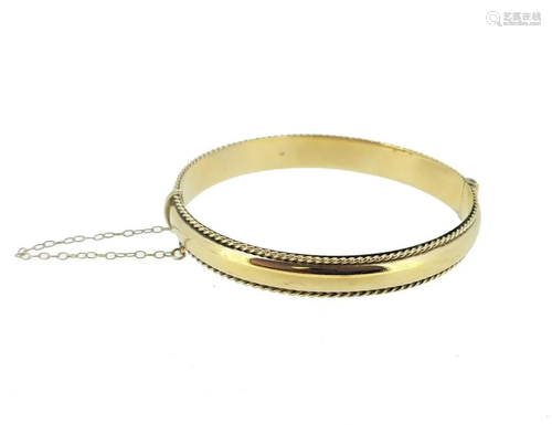 A 9ct gold hinged bangle,