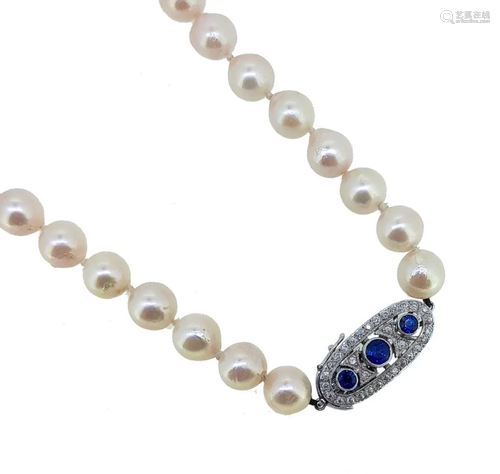 A single row of pearls with a sapphire and diamond clasp,