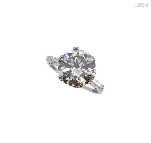 A diamond single stone ring with diamond set shoulders,