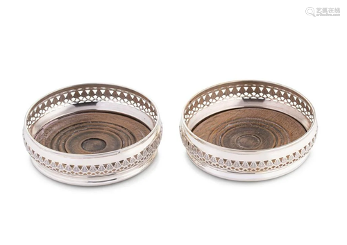 A pair of late 20th century silver bottle coasters,