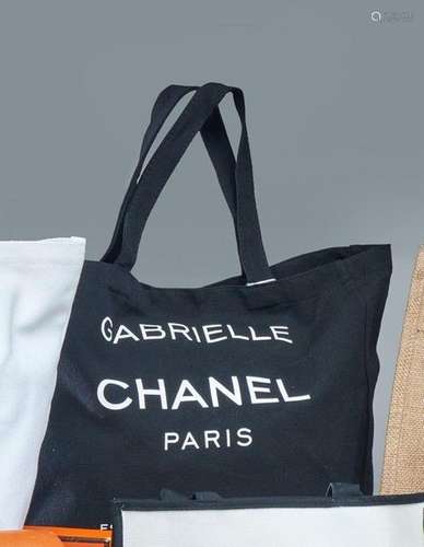 CHANEL<br />
TOTE-BAG en toile noire portant l'inscription à...