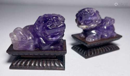 A PAIR OF CHINESE AMETHYST FOO DOGS ON WOODEN STANDS, QING D...