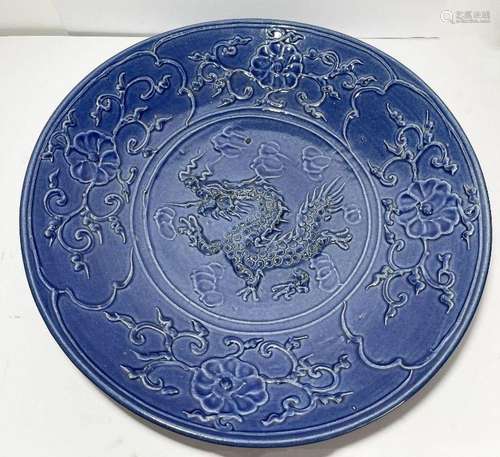 A CHINESE BLUE CHARGER WITH EMBOSSED DRAGONS