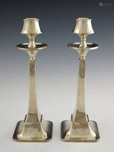 A pair of Arts and Crafts silver candles