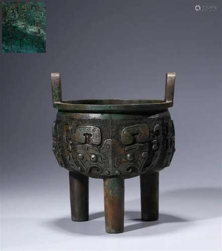 Tripod with bronze animal face pattern