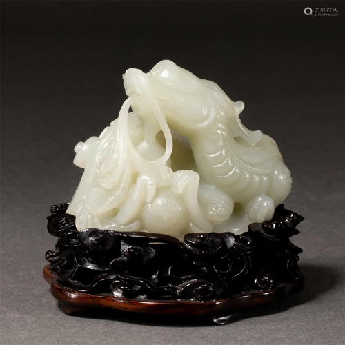 A CHINESE CARVED WHITE JADE DRAGON