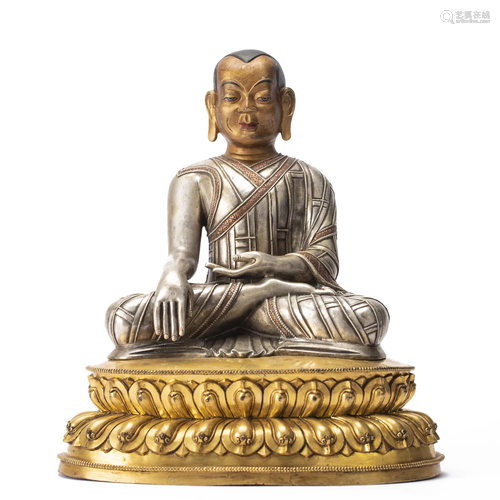 A TIBETAN SILVER-GILT FIGURE OF MASTER